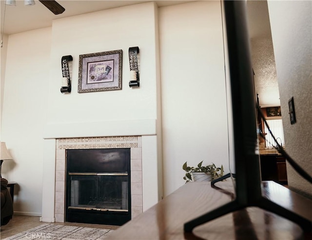 25657 Tamarisk St, Barstow, CA 92311 - detailed view of a tile fireplace, ceiling fan, and baseboards