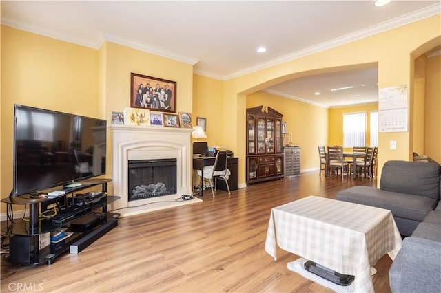 10148 Fernglen Ave Unit 2, Tujunga, CA 91042 - living room with arched walkways, wood finished floors, a fireplace with raised hearth, crown molding, and baseboards