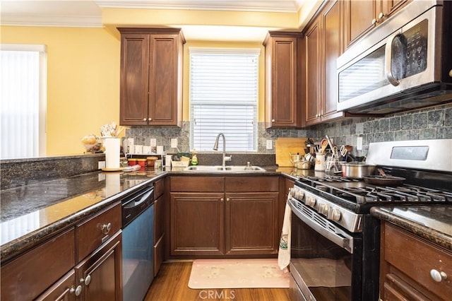 10148 Fernglen Ave Unit 2, Tujunga, CA 91042 - kitchen featuring appliances with stainless steel finishes, a sink, crown molding, dark stone counters, and backsplash