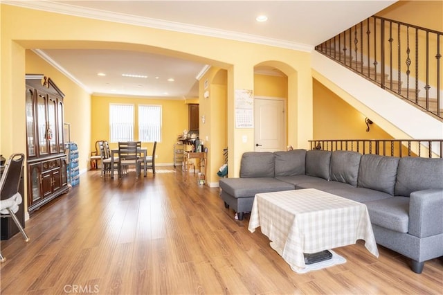 10148 Fernglen Ave Unit 2, Tujunga, CA 91042 - living room featuring arched walkways, light wood-type flooring, ornamental molding, stairway, and recessed lighting