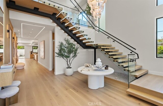 5772 Sierra Casa Rd, Irvine, CA 92603 - stairway featuring wood finished floors, plenty of natural light, and baseboards