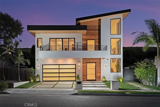 5772 Sierra Casa Rd, Irvine, CA 92603 - contemporary house with a balcony, driveway, an attached garage, and stucco siding