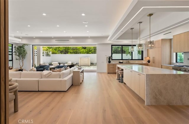 5772 Sierra Casa Rd, Irvine, CA 92603 - living room with light wood-type flooring, recessed lighting, plenty of natural light, and a chandelier