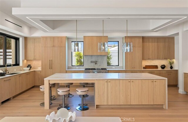 5772 Sierra Casa Rd, Irvine, CA 92603 - kitchen with light brown cabinets, modern cabinets, a sink, and tasteful backsplash
