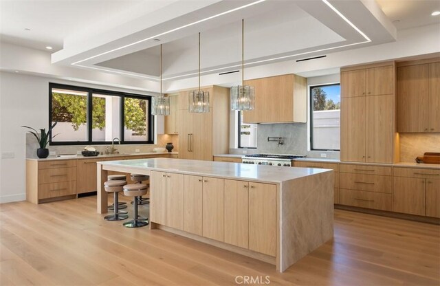 5772 Sierra Casa Rd, Irvine, CA 92603 - kitchen featuring modern cabinets, light brown cabinetry, a center island, and recessed lighting