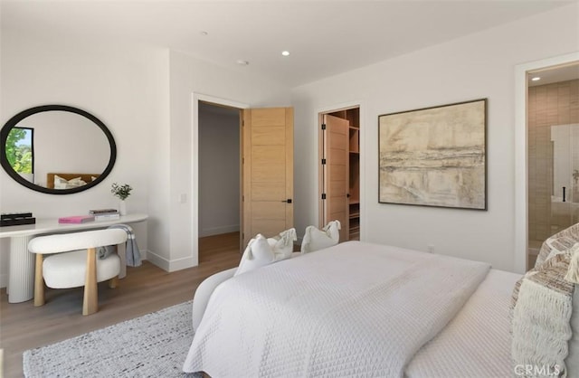 5772 Sierra Casa Rd, Irvine, CA 92603 - bedroom with wood finished floors, a walk in closet, recessed lighting, baseboards, and ensuite bathroom