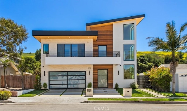 5772 Sierra Casa Rd, Irvine, CA 92603 - modern home with a balcony, driveway, a garage, and stucco siding
