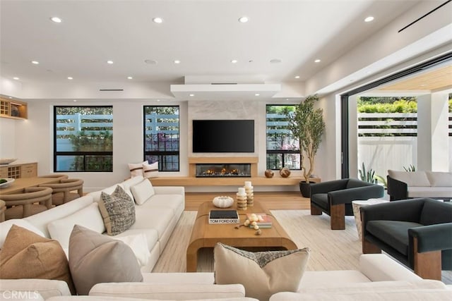 5772 Sierra Casa Rd, Irvine, CA 92603 - living area featuring recessed lighting, a high end fireplace, healthy amount of natural light, and wood finished floors