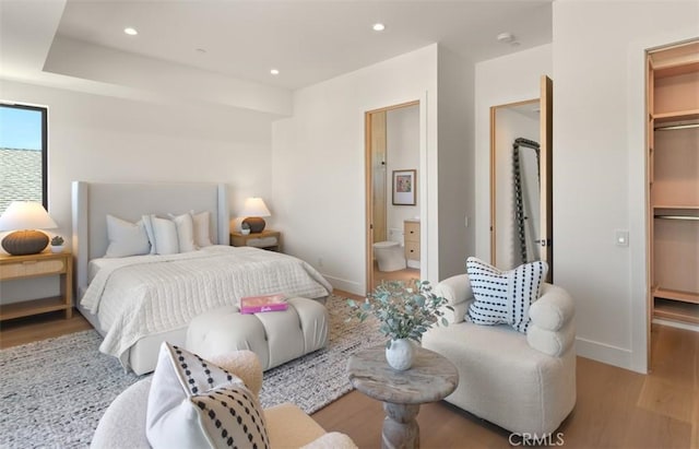 5772 Sierra Casa Rd, Irvine, CA 92603 - bedroom featuring wood finished floors, a walk in closet, baseboards, recessed lighting, and ensuite bath