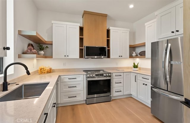 5772 Sierra Casa Rd, Irvine, CA 92603 - kitchen featuring open shelves, stainless steel appliances, a sink, light wood finished floors, and recessed lighting