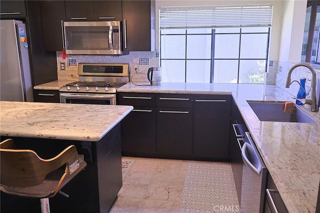 6508 Sandy Point Ct, Rancho Palos Verdes, CA 90275 - kitchen with appliances with stainless steel finishes, decorative backsplash, and light stone countertops