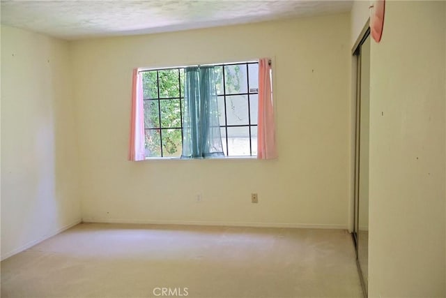 unfurnished bedroom featuring carpet, a closet, and baseboards