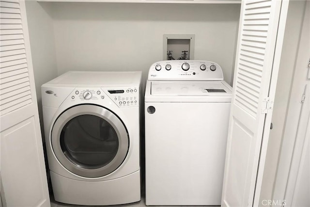 clothes washing area featuring washing machine and dryer