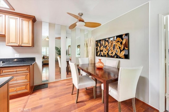 2049 Via Mariposa Unit E, Laguna Woods, CA 92637 - dining area with light wood-style floors and a ceiling fan