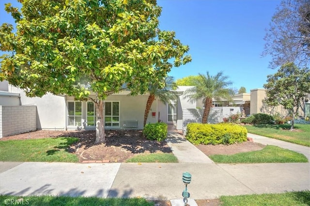2049 Via Mariposa Unit E, Laguna Woods, CA 92637 - view of front of home featuring stucco siding and fence