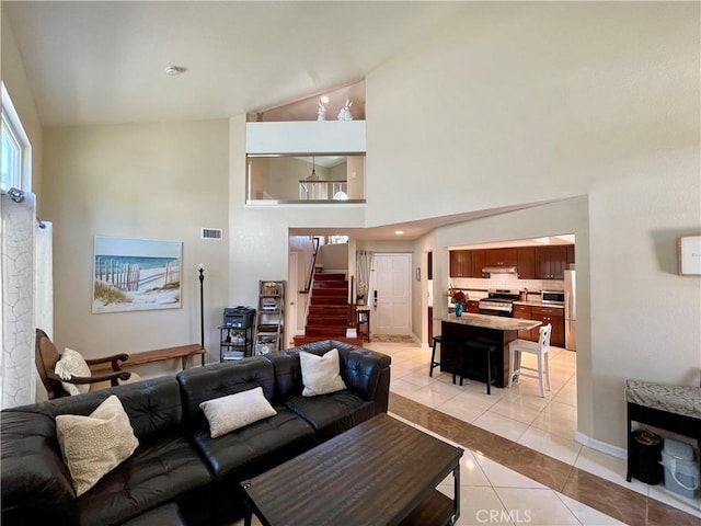 4166 Winged Foot Way, Chino Hills, CA 91709 - living area featuring light tile patterned floors, stairway, high vaulted ceiling, and baseboards