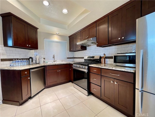 4166 Winged Foot Way, Chino Hills, CA 91709 - kitchen featuring appliances with stainless steel finishes, under cabinet range hood, a sink, decorative backsplash, and light stone countertops