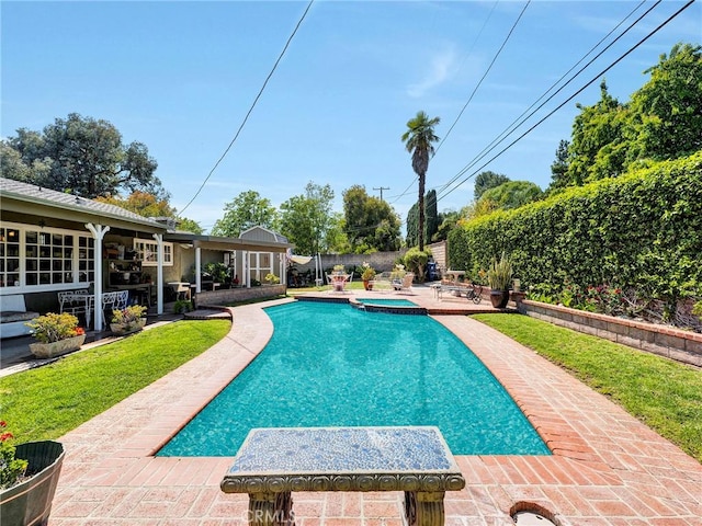 view of swimming pool with a patio and a pool with connected hot tub