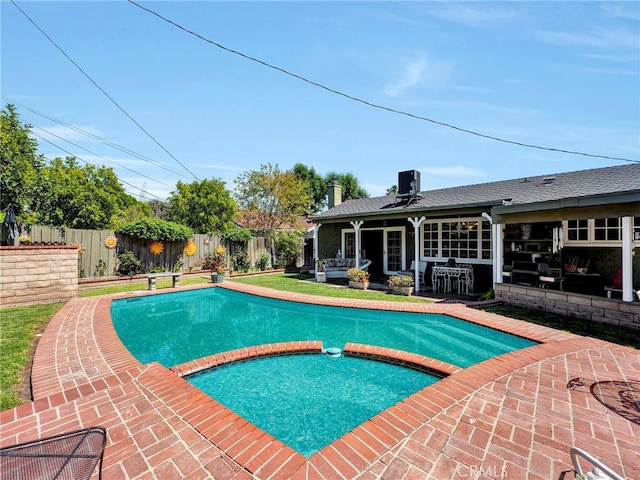 view of swimming pool featuring a fenced backyard, a patio area, central AC unit, and a pool with connected hot tub