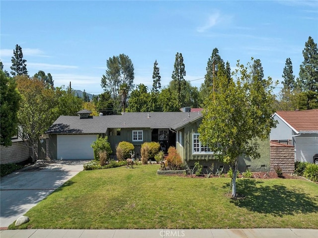 view of front of home with an attached garage, a front yard, and driveway