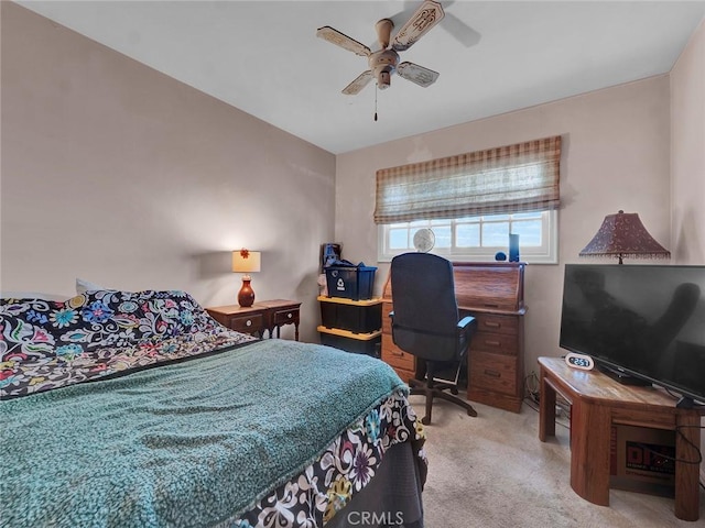 carpeted bedroom featuring ceiling fan and an office area