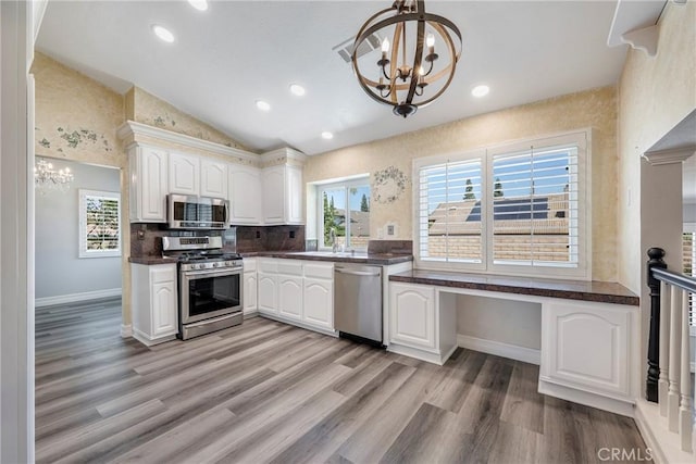 17275 Growers Cir, Yorba Linda, CA 92886 - kitchen with stainless steel appliances, a chandelier, dark countertops, vaulted ceiling, and a sink