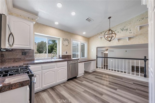 17275 Growers Cir, Yorba Linda, CA 92886 - kitchen with appliances with stainless steel finishes, a sink, a chandelier, a ceiling fan, and white cabinets