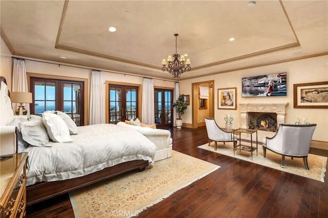 12 Skyridge, Newport Coast, CA 92657 - bedroom featuring a raised ceiling, french doors, ornamental molding, baseboards, and a chandelier