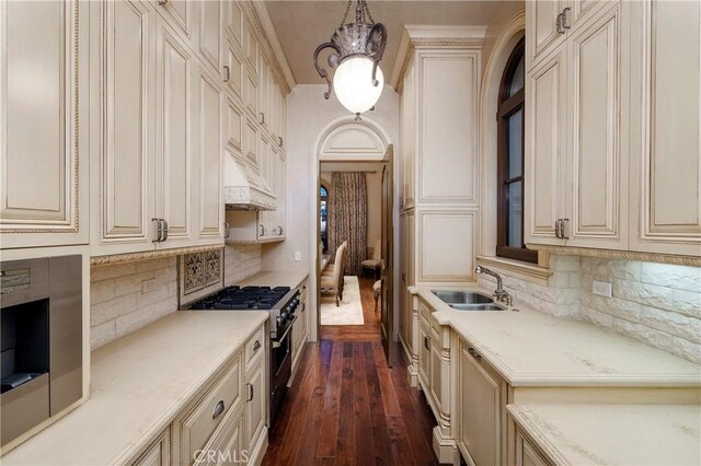 12 Skyridge, Newport Coast, CA 92657 - kitchen with stainless steel stove, cream cabinetry, and a sink