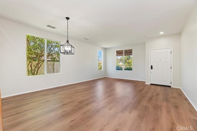 8167 Faircrest Rd, Riverside, CA 92508 - unfurnished dining area with plenty of natural light, light wood-type flooring, a chandelier, recessed lighting, and baseboards