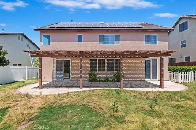 8167 Faircrest Rd, Riverside, CA 92508 - back of house with a pergola, a patio, solar panels, and stucco siding