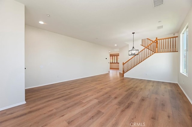 8167 Faircrest Rd, Riverside, CA 92508 - unfurnished living room featuring plenty of natural light, light wood finished floors, stairway, and recessed lighting