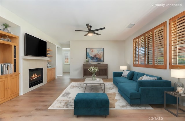 8167 Faircrest Rd, Riverside, CA 92508 - living area with a ceiling fan, wood finished floors, and a glass covered fireplace