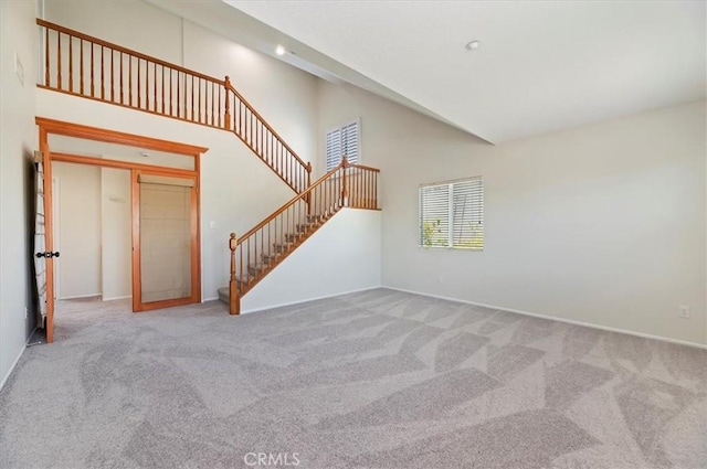 8167 Faircrest Rd, Riverside, CA 92508 - unfurnished living room featuring carpet floors, stairs, high vaulted ceiling, baseboards, and recessed lighting