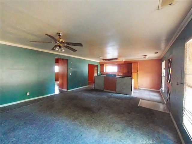 410 5th St, Willows, CA 95988 - unfurnished living room with ornamental molding, baseboards, dark carpet, and a ceiling fan