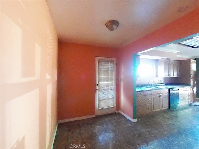 410 5th St, Willows, CA 95988 - kitchen with dishwasher, baseboards, a sink, and light countertops