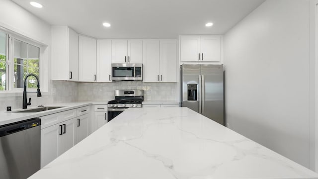 5259 Imperial Ave, San Diego, CA 92114 - kitchen featuring stainless steel appliances, a sink, backsplash, recessed lighting, and white cabinetry