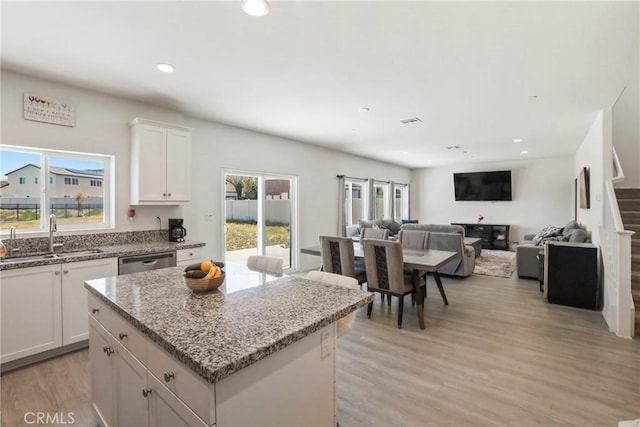 30527 Expedition Dr, Winchester, CA 92596 - kitchen with stainless steel dishwasher, white cabinetry, recessed lighting, light stone counters, and light wood-type flooring