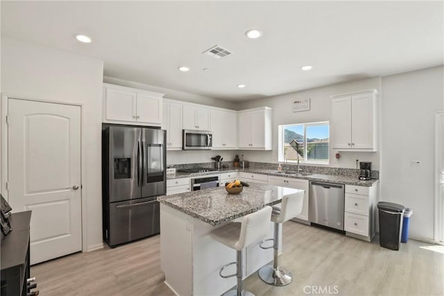 30527 Expedition Dr, Winchester, CA 92596 - kitchen featuring appliances with stainless steel finishes, light wood-type flooring, white cabinets, and recessed lighting