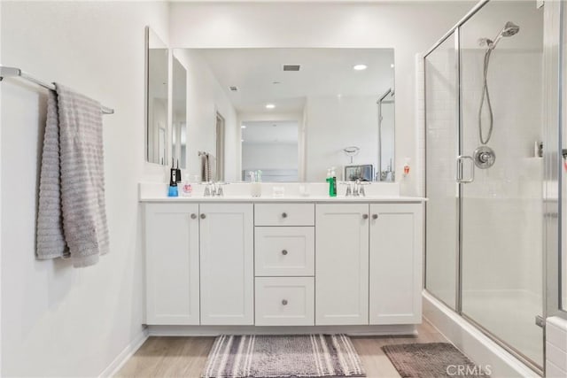 30527 Expedition Dr, Winchester, CA 92596 - full bathroom with a shower stall, wood finished floors, double vanity, and recessed lighting