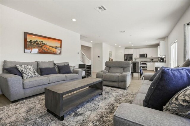 30527 Expedition Dr, Winchester, CA 92596 - living area featuring light wood-type flooring, stairs, and recessed lighting