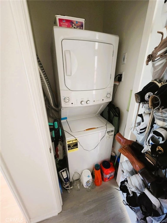30527 Expedition Dr, Winchester, CA 92596 - laundry area with stacked washer and clothes dryer and wood finished floors