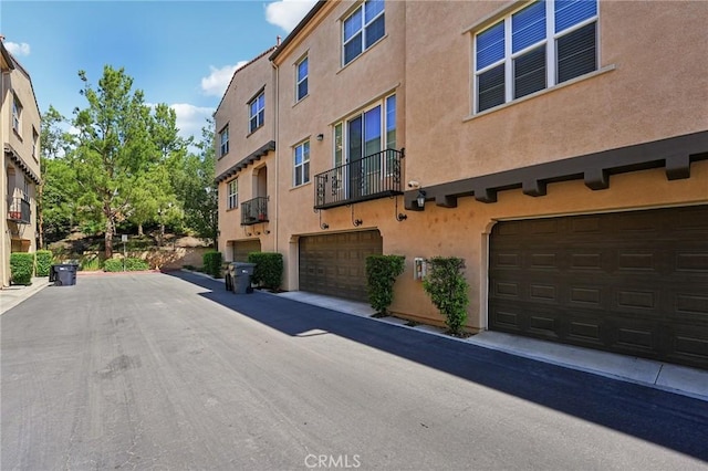 4437 Owens St Unit 104, Corona, CA 92883 - view of building exterior with an attached garage
