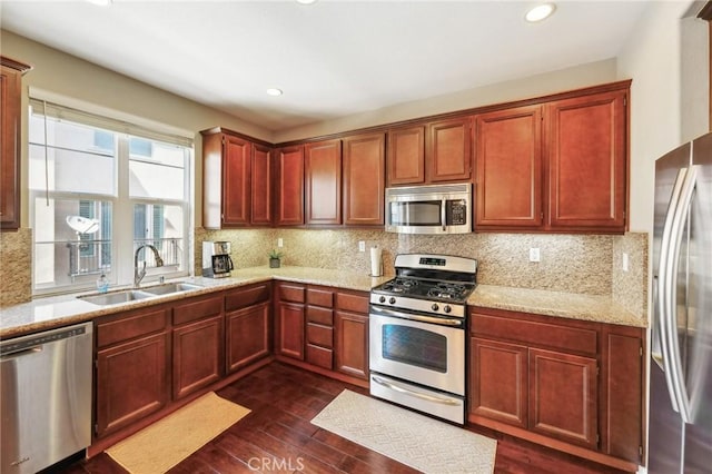 4437 Owens St Unit 104, Corona, CA 92883 - kitchen featuring appliances with stainless steel finishes, a sink, dark wood-type flooring, tasteful backsplash, and recessed lighting