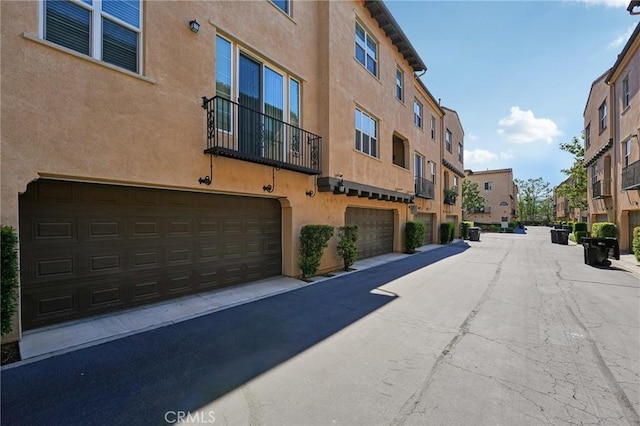 4437 Owens St Unit 104, Corona, CA 92883 - view of building exterior featuring a residential view and a garage