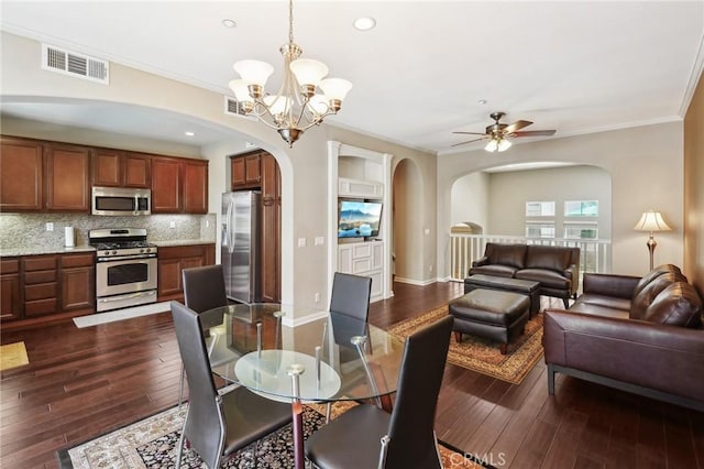4437 Owens St Unit 104, Corona, CA 92883 - dining room featuring arched walkways, ornamental molding, a ceiling fan, dark wood-style floors, and a chandelier