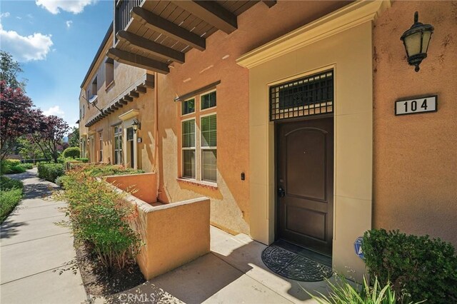 4437 Owens St Unit 104, Corona, CA 92883 - property entrance featuring stucco siding and covered porch
