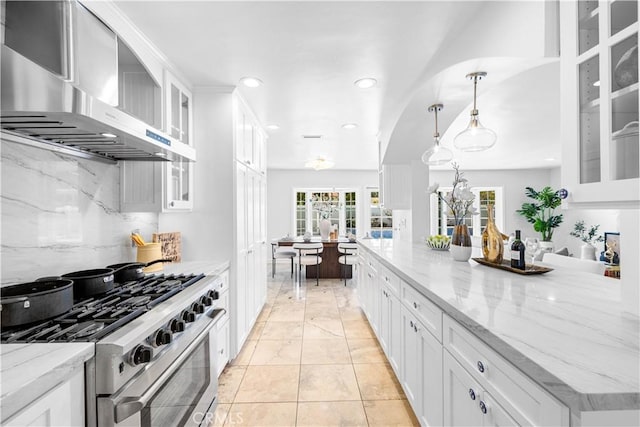 20 Grant, Irvine, CA 92620 - kitchen with gas stove, wall chimney range hood, white cabinets, recessed lighting, and light stone counters
