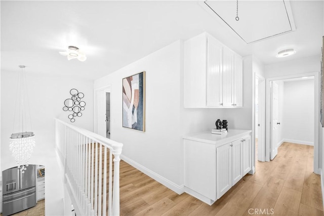 20 Grant, Irvine, CA 92620 - corridor featuring attic access, light wood-style floors, and baseboards