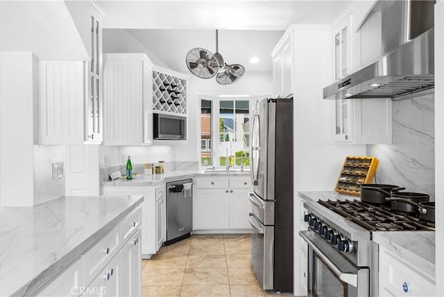 20 Grant, Irvine, CA 92620 - kitchen featuring appliances with stainless steel finishes, wall chimney exhaust hood, white cabinetry, light stone countertops, and recessed lighting